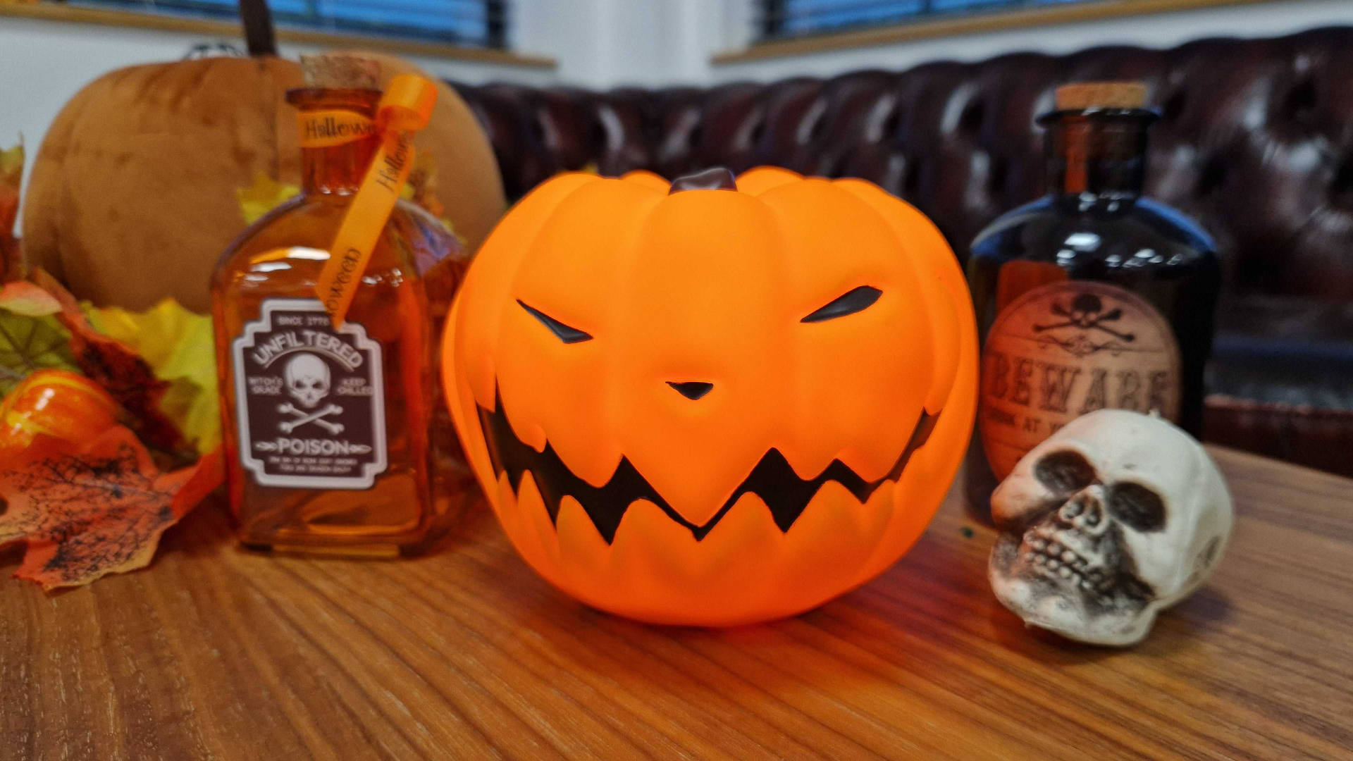 Disney Nightmare Before Christmas Pumpkin glowing amongst other Halloween decorations