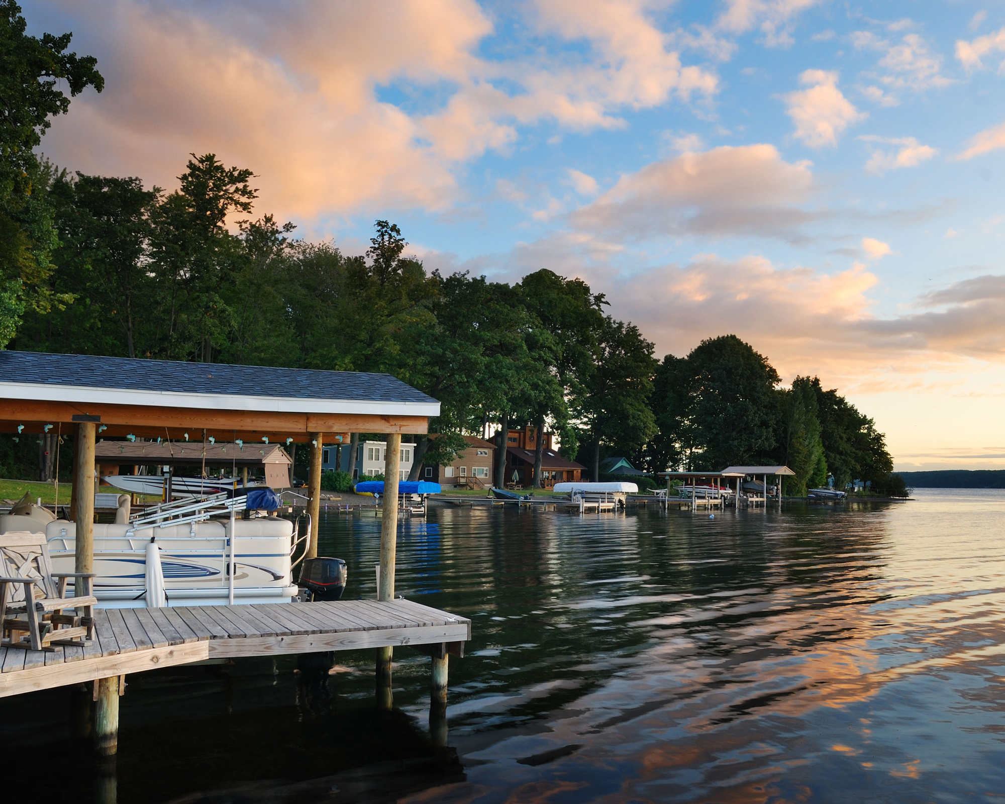 Lake house with pier and woods with sunrise in the morning in New York state Finger Lakes