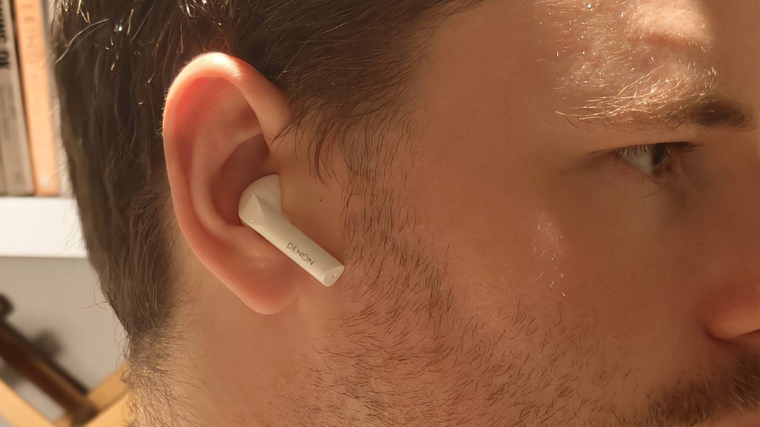 The Denon AH-C500W in a man's ear.