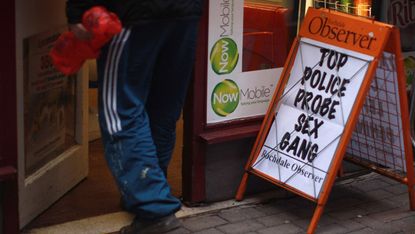 A newspaper board outside a Rochdale shop 