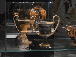 Ancient vases behind glass