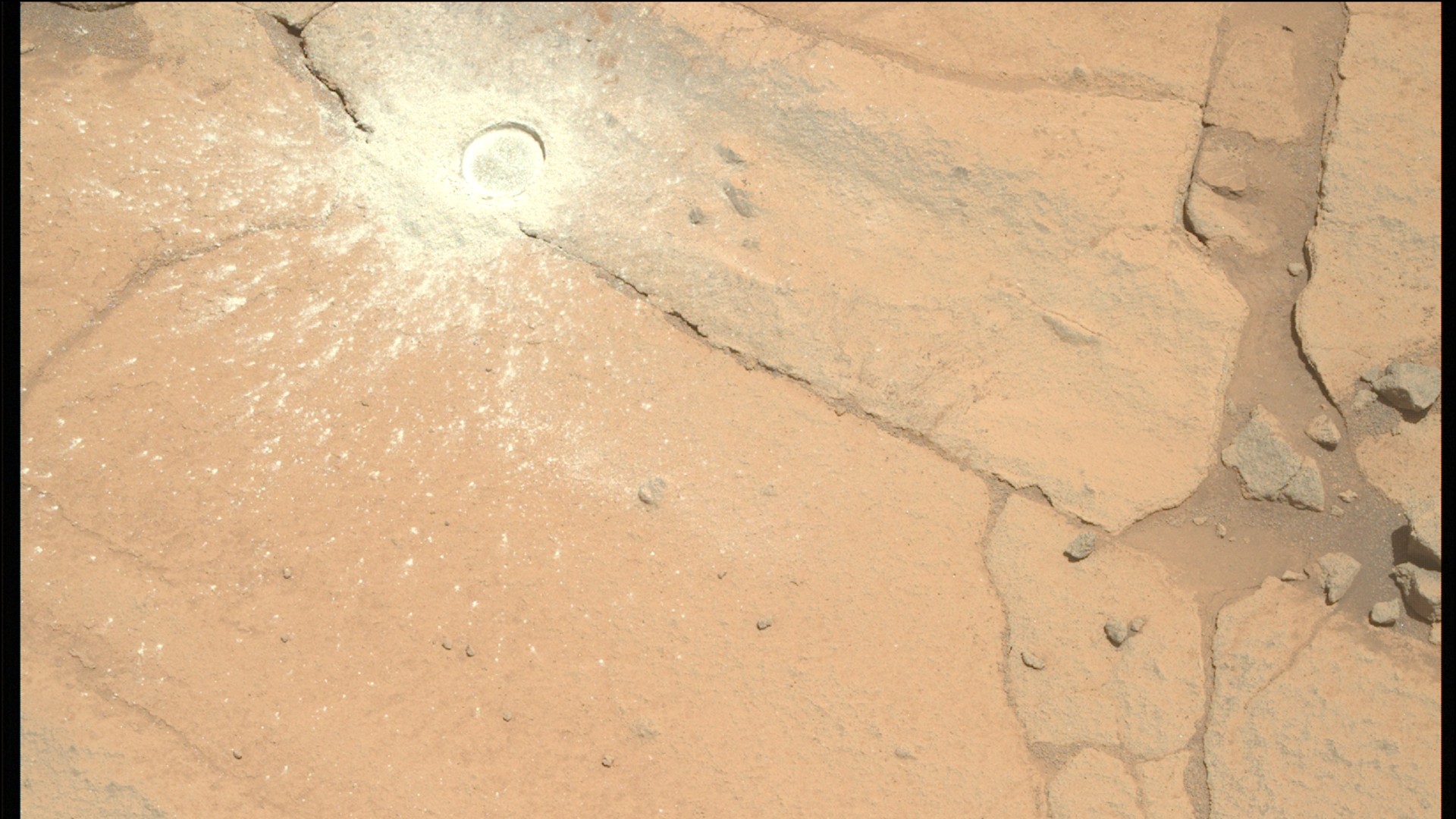 a circle of white powder on an orange dusty surface