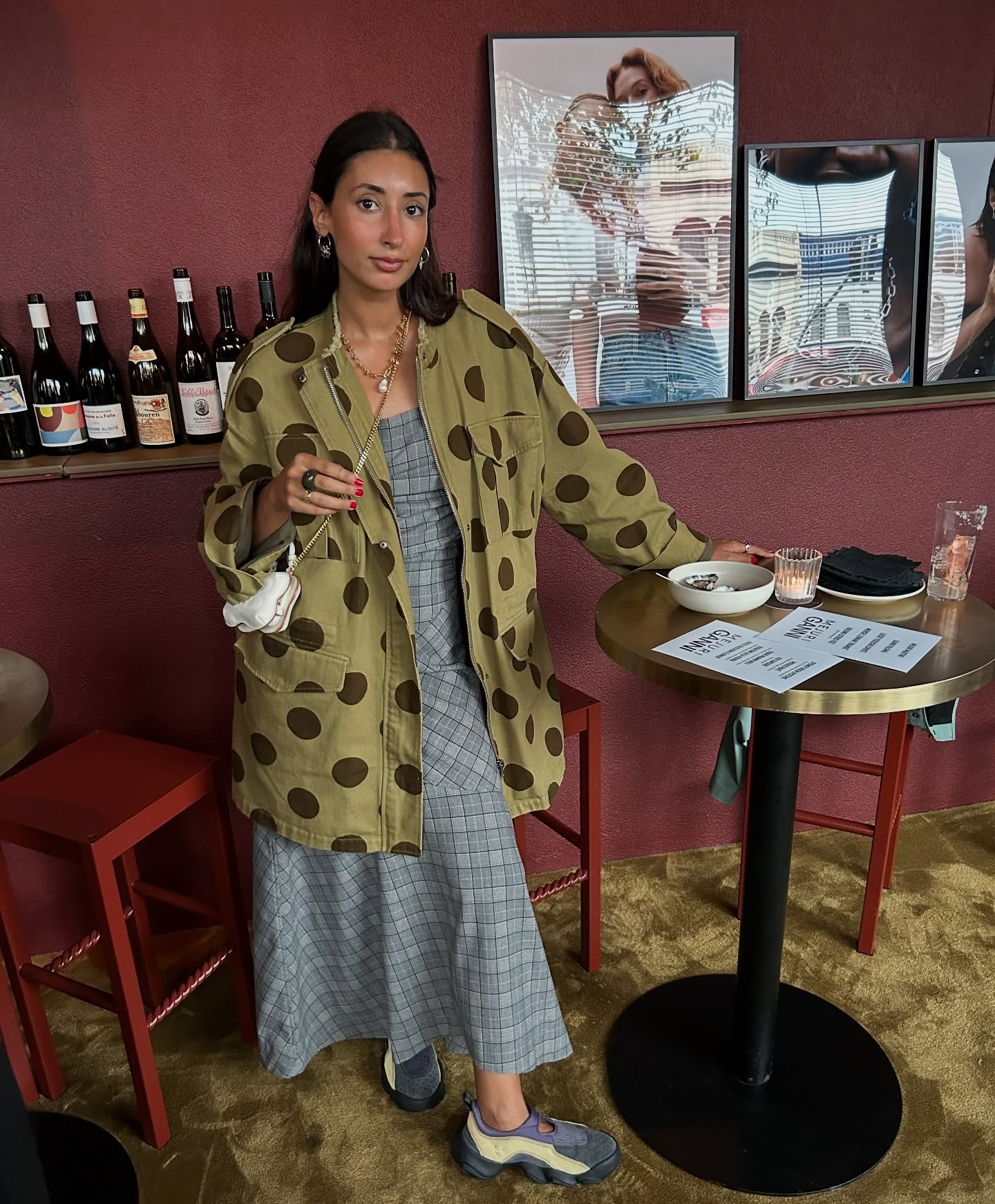 Influencer @barbarasantiago.r wears technical trainers with a polka-dot jacket and a checked skirt.