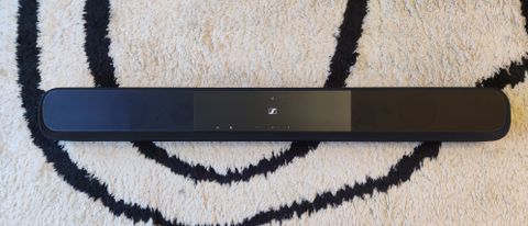 The Sennheiser Ambeo Soundbar Plus on a black and white carpet
