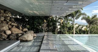 bridge house swimming pool with rippling blue waters and infinity edge towards the sea