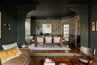 view from living room with olive green walls to dining room with decorative wallpaper