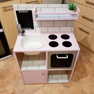 homemade play kitchen with wooden flooring and sink bowl