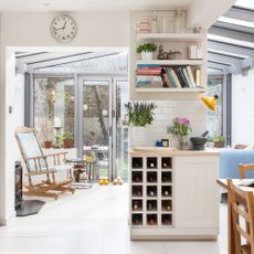 open plan kitchen and dining space with rocking chair and open shelves