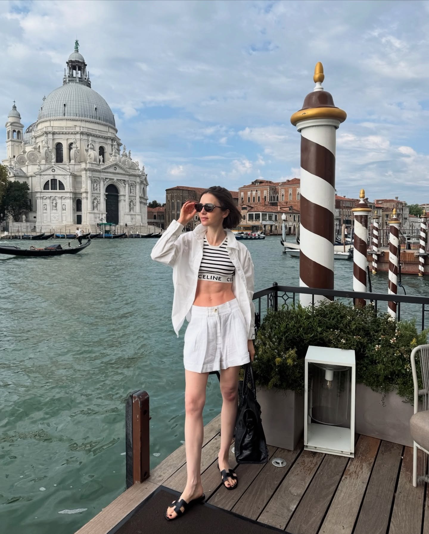 Lily Collins wears a striped bra top in Venice, Italy