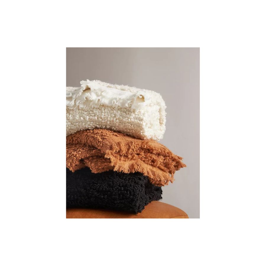 boucle throws in white, brown and black, folded