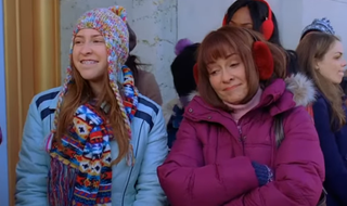 Eden Sher as Sue and Patricia Heaton as Frankie standing and smiling in The Middle.