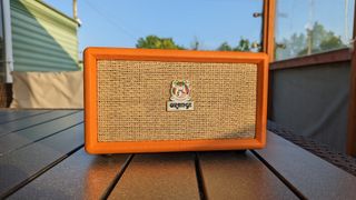 The Orange Box Bluetooth speaker on an outdoor table