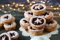 Stacked mince pies dusted with icing sugar