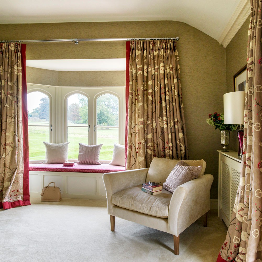 bedroom with white armchair and cushions