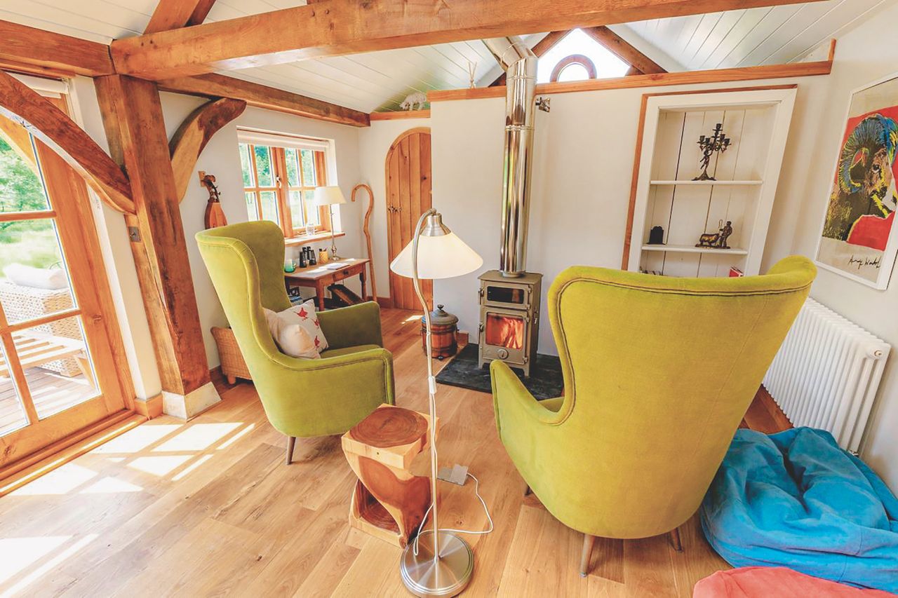 small living room with vaulted ceiling and woodburning stove