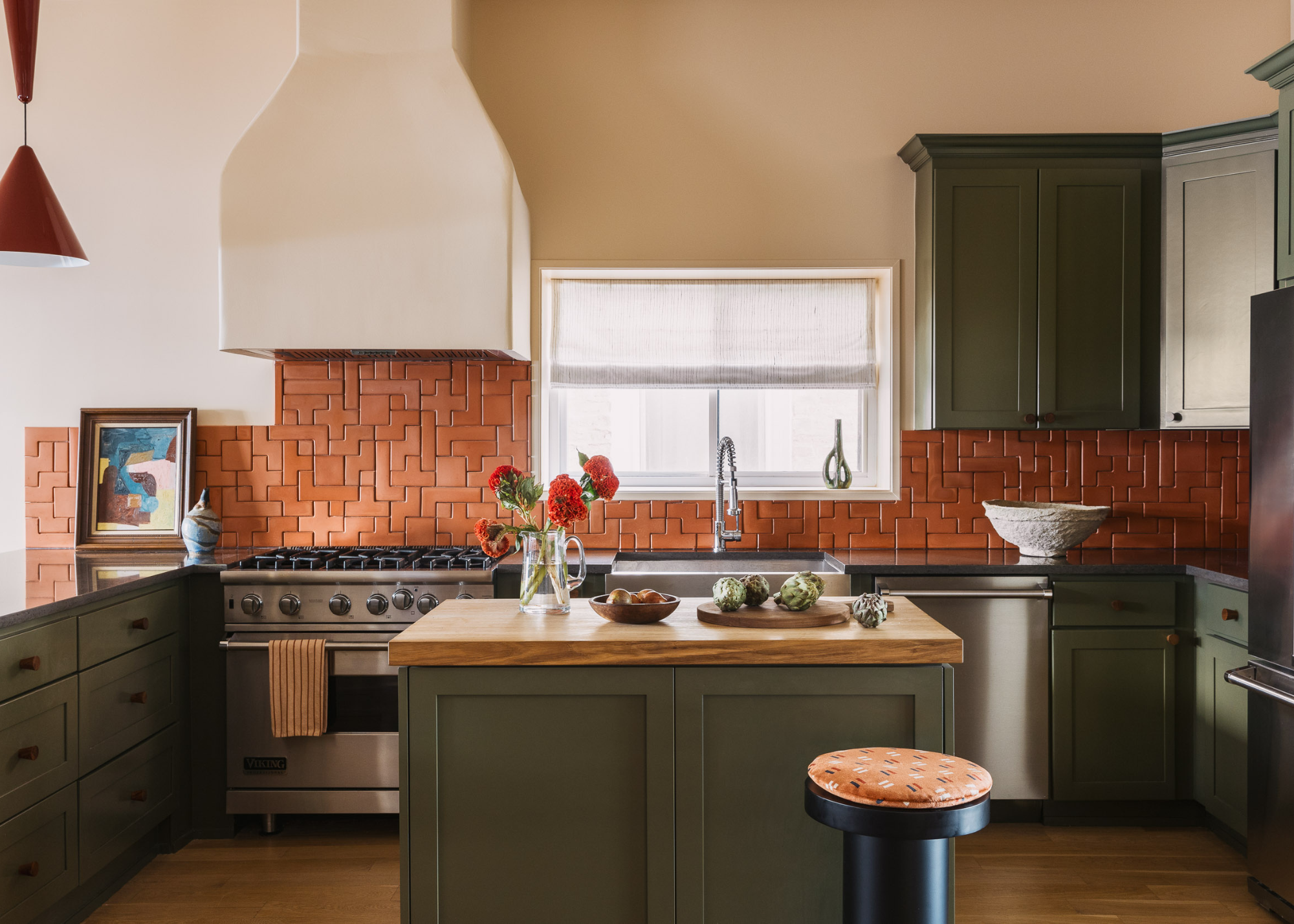 traditional kitchen with green cabinets,a plaster hood and tetris tiled backsplash
