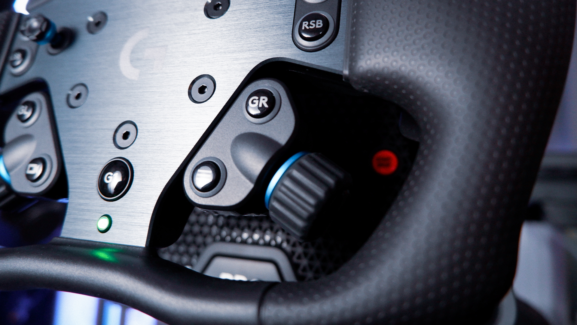 The Logitech G RS Wheel Hub and RS Track Wheel on a desk and installed on a sim racing wheel base.