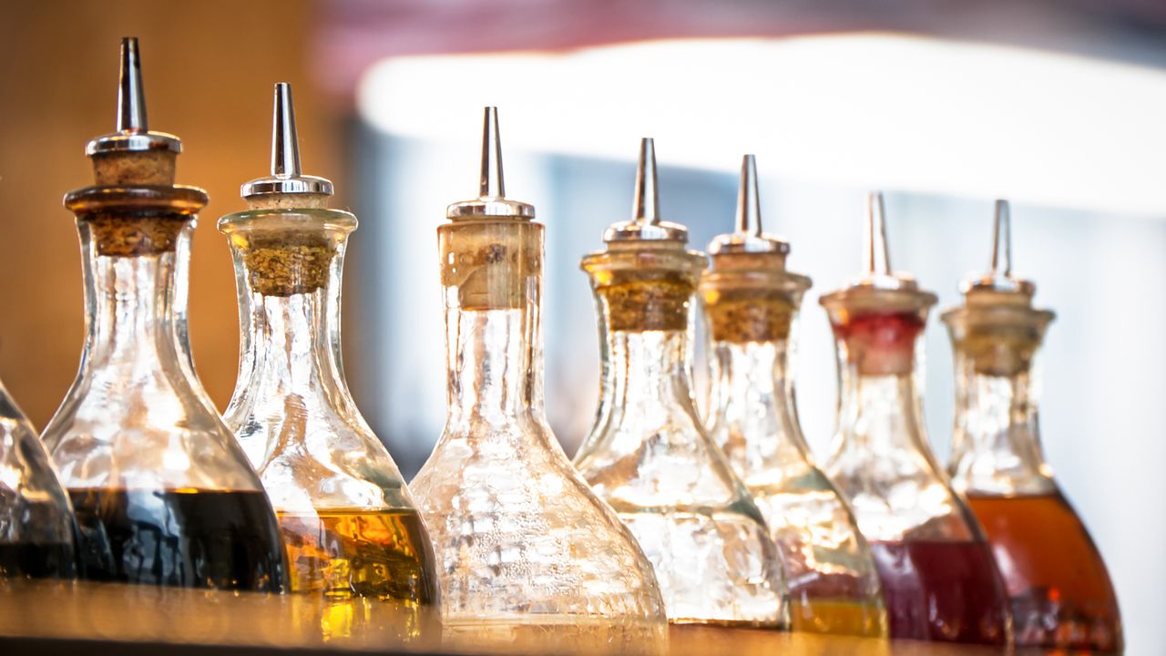 Row of rounded glass bottles of vinegar