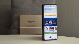 Amazon app on the Samsung Galaxy Z Fold 3 with a Kindle Oasis in the background