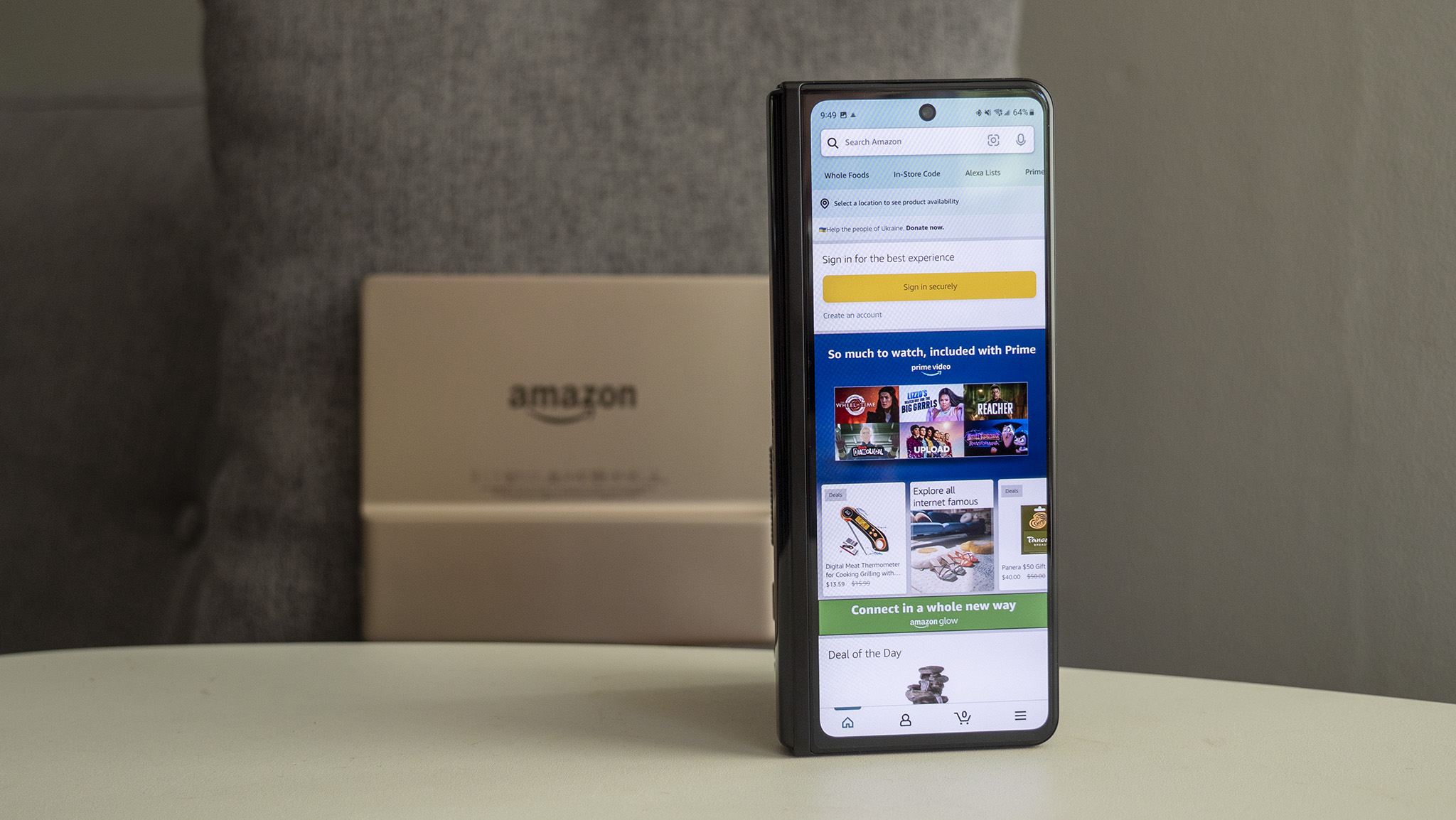 Amazon app on the Samsung Galaxy Z Fold 3 with a Kindle Oasis in the background