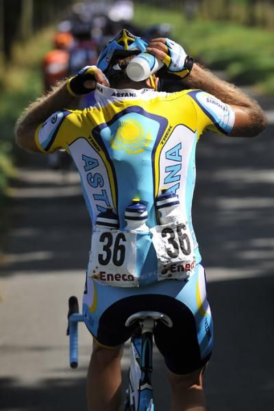 Gr&eacute;gory Rast (Astana) gathers drinks for his teammates during stage 1.