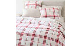 A red and white plaid Christmas bedding set.