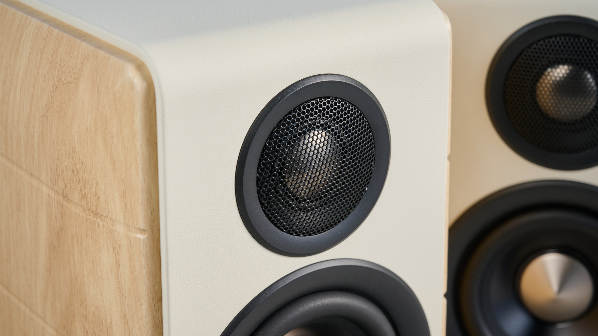 the edifier s880db mkii speakers in white and wood colorway showing the connectivity options, remote control, against a blue background