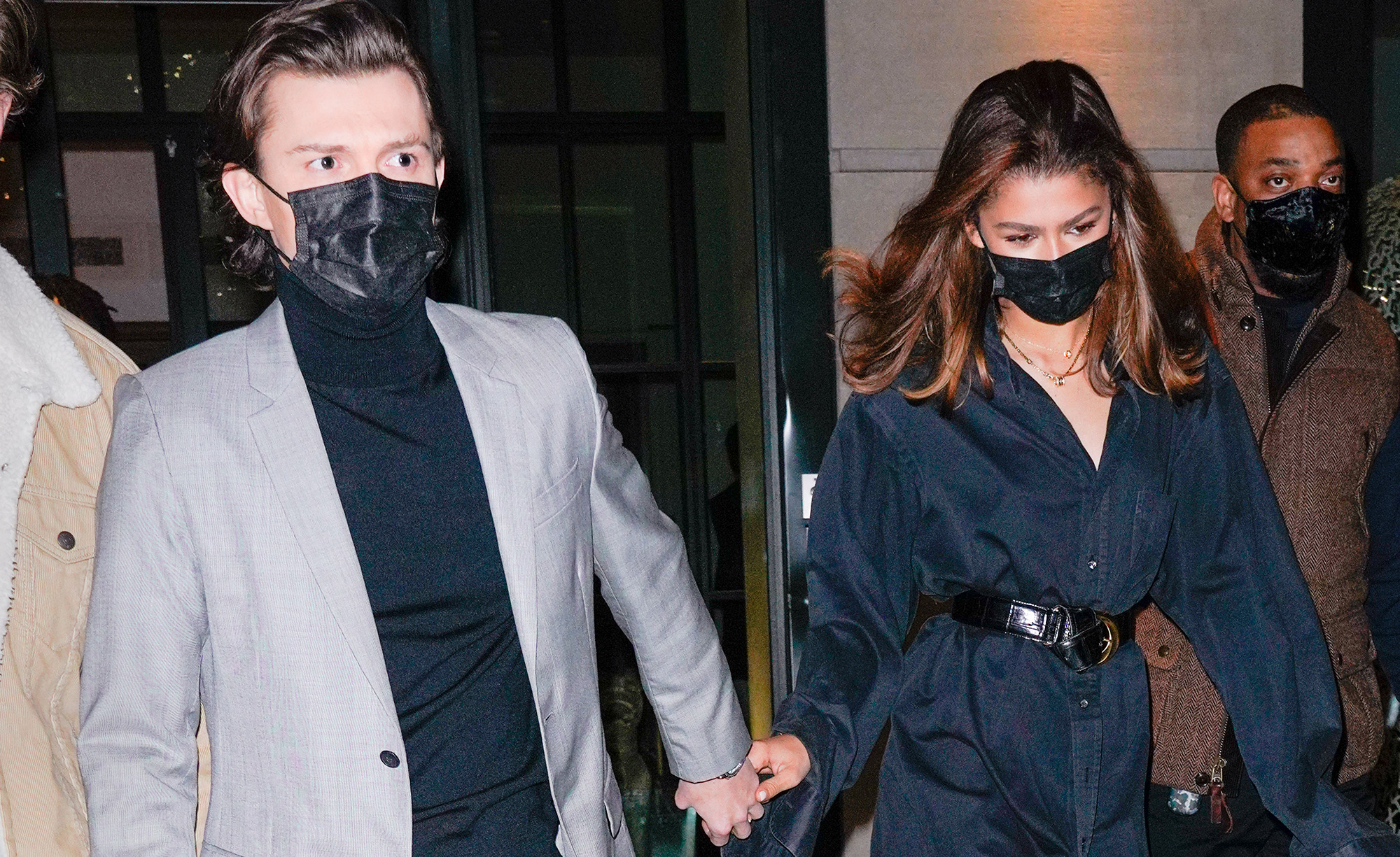 Tom Holland and Zendaya holding hands in masks in 2022.