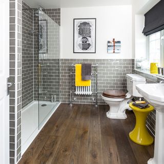White, grey and yellow bathroom with wooden floors