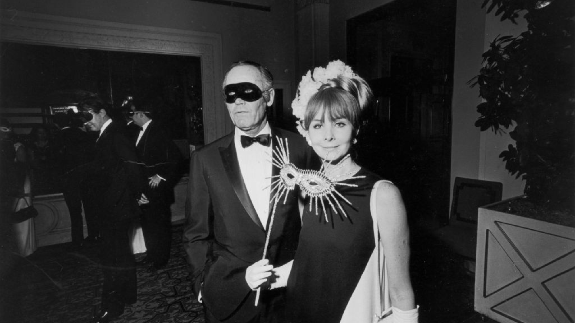 Henry Fonda and his wife Shirlee Mae Adams at the black and white ball in 1966, both carrying eye masks