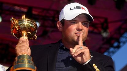 Patrick Reed of Team USA holds the Ryder Cup trophy to celebrate beating Europe