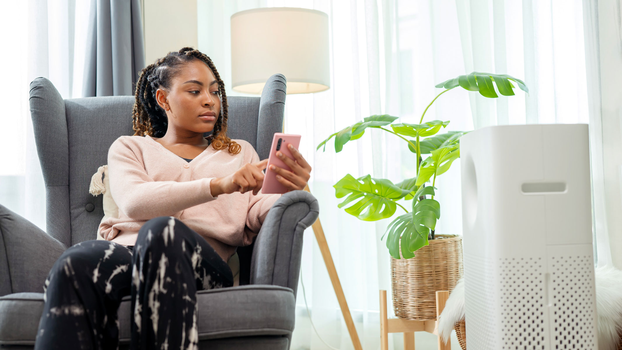 a woman switching on an air purifier