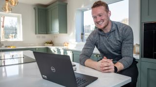 Greg Rutherford sits in a stylish kitchen interviewing a range of Olympic athletes via his laptop