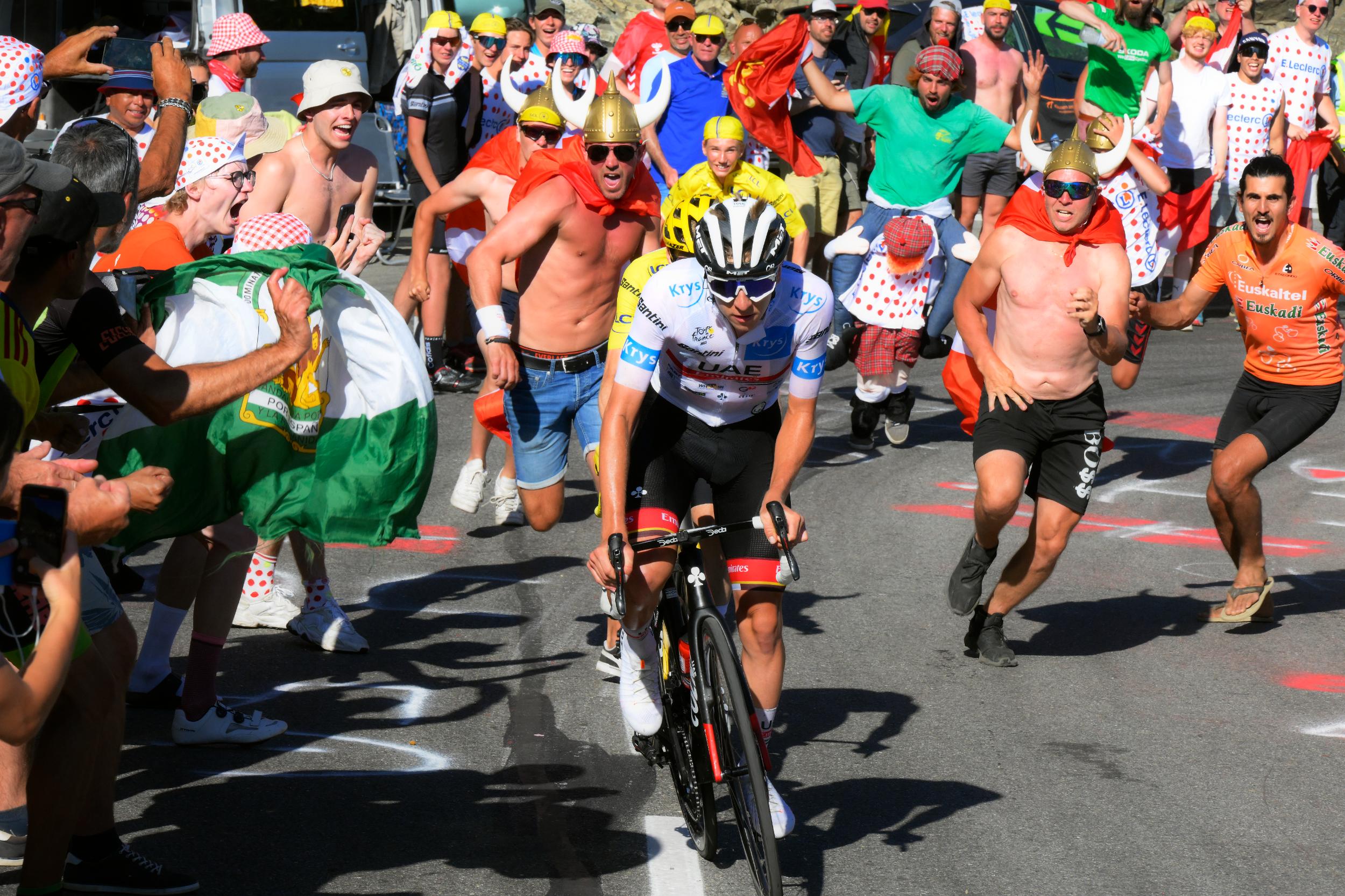 Tadej Pogačar surrounded by fans on Alpe d'Huez in 2022