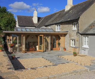 oak frame conservatory attached to cottage leading onto patio