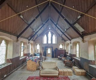 Inside a chapel with wooden ceilings and stone flooring with stained glass windows