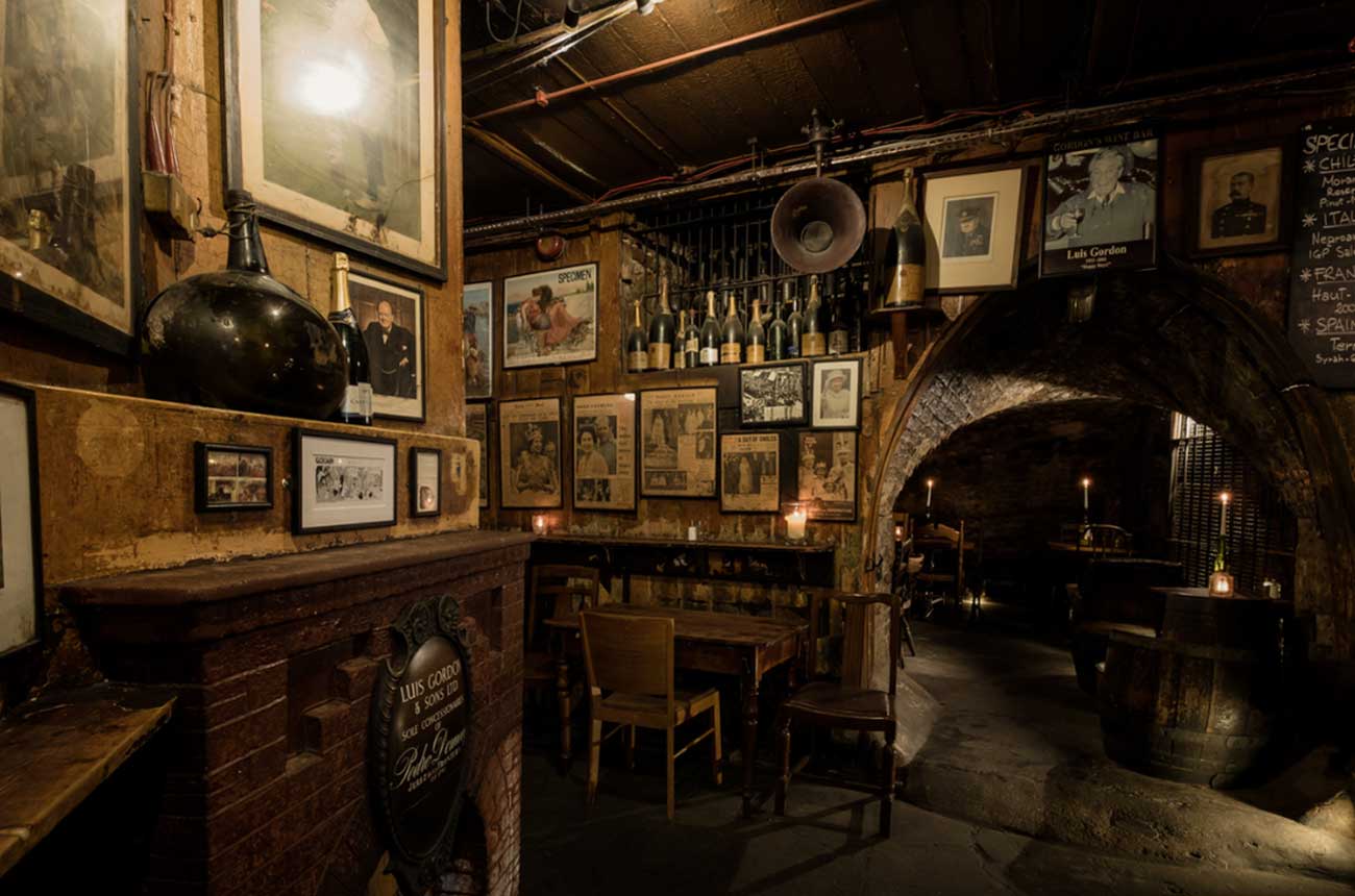 A dark bar interior with old photos