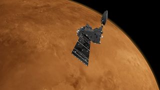 spacecraft orbiting mars with blackness of space in the background.