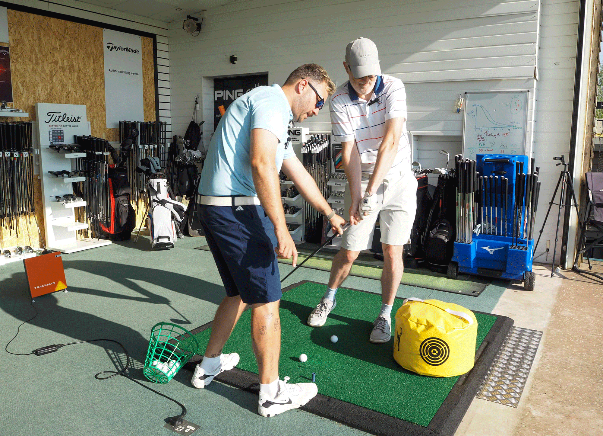 Rob Spedding working with coach Josh Mayo in the studio on his golf swing