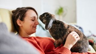 Woman cuddling with rabbit