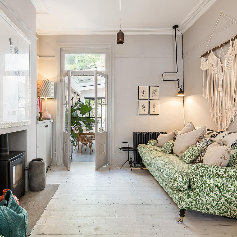 white living room with green sofa and lamp