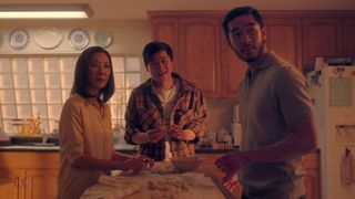 Mama, Bruce, and Charles make dinner as they see someone off camera in Netflix's The Brothers Sun