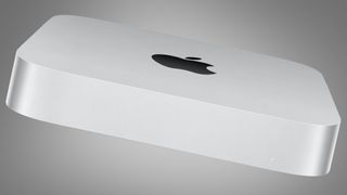 Apple Mac Mini M2 harmaata taustaa vasten