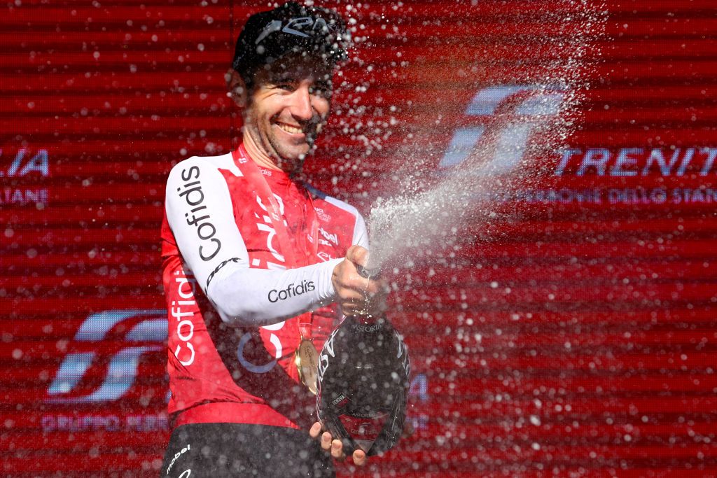 Team Cofidis' French rider Benjamin Thomas celebrates on the podium after winning the 5th stage of the 107th Giro d'Italia cycling race, 178 km between Genova and Lucca, on May 8, 2024 in Lucca. Thomas won ahead of Team EF Education's Danish rider Michael Valgren, second, and Team Polti-Kometa's Italian rider Andrea Pietrobon, third. (Photo by Luca Bettini / AFP)