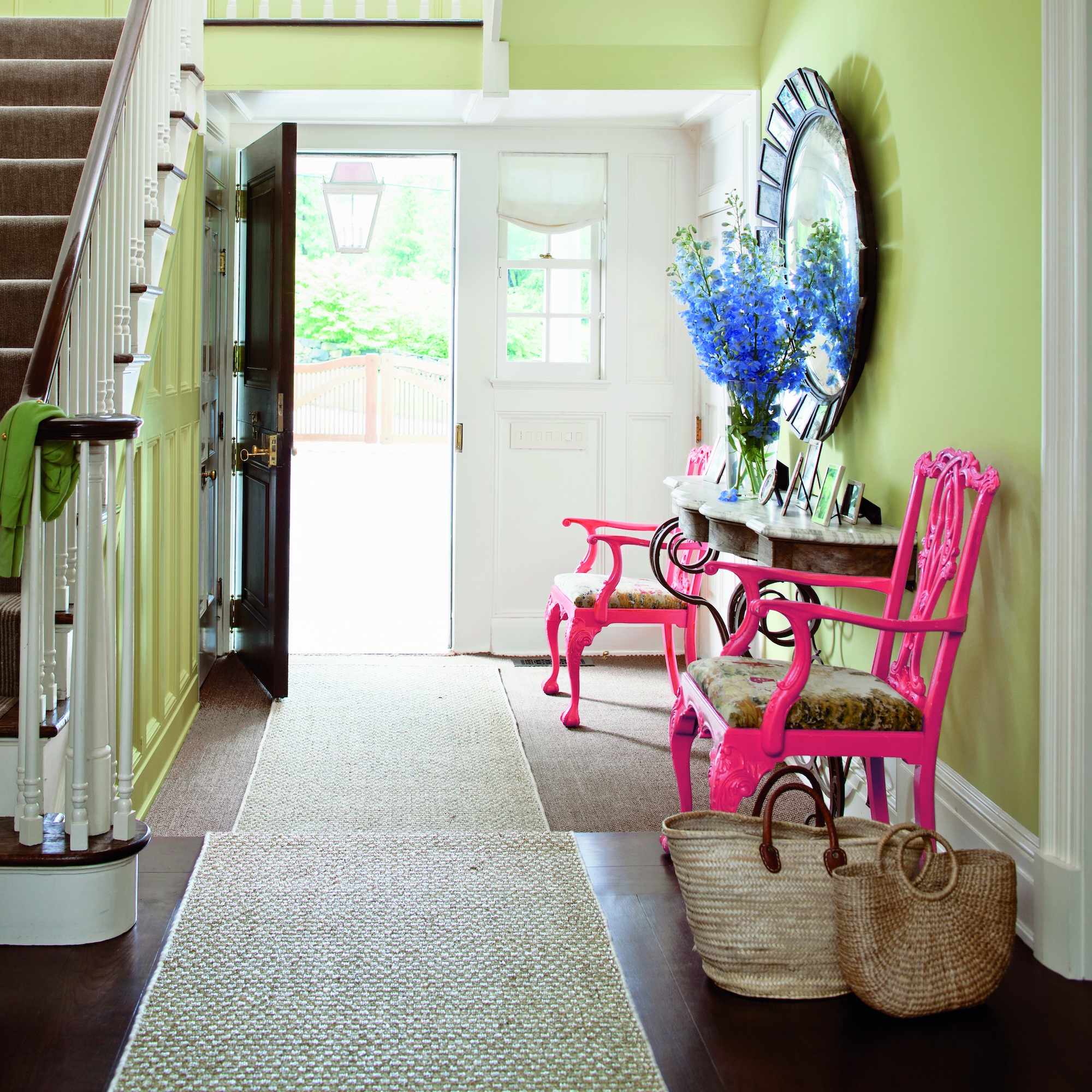Pale green hallway with neon pink chairs