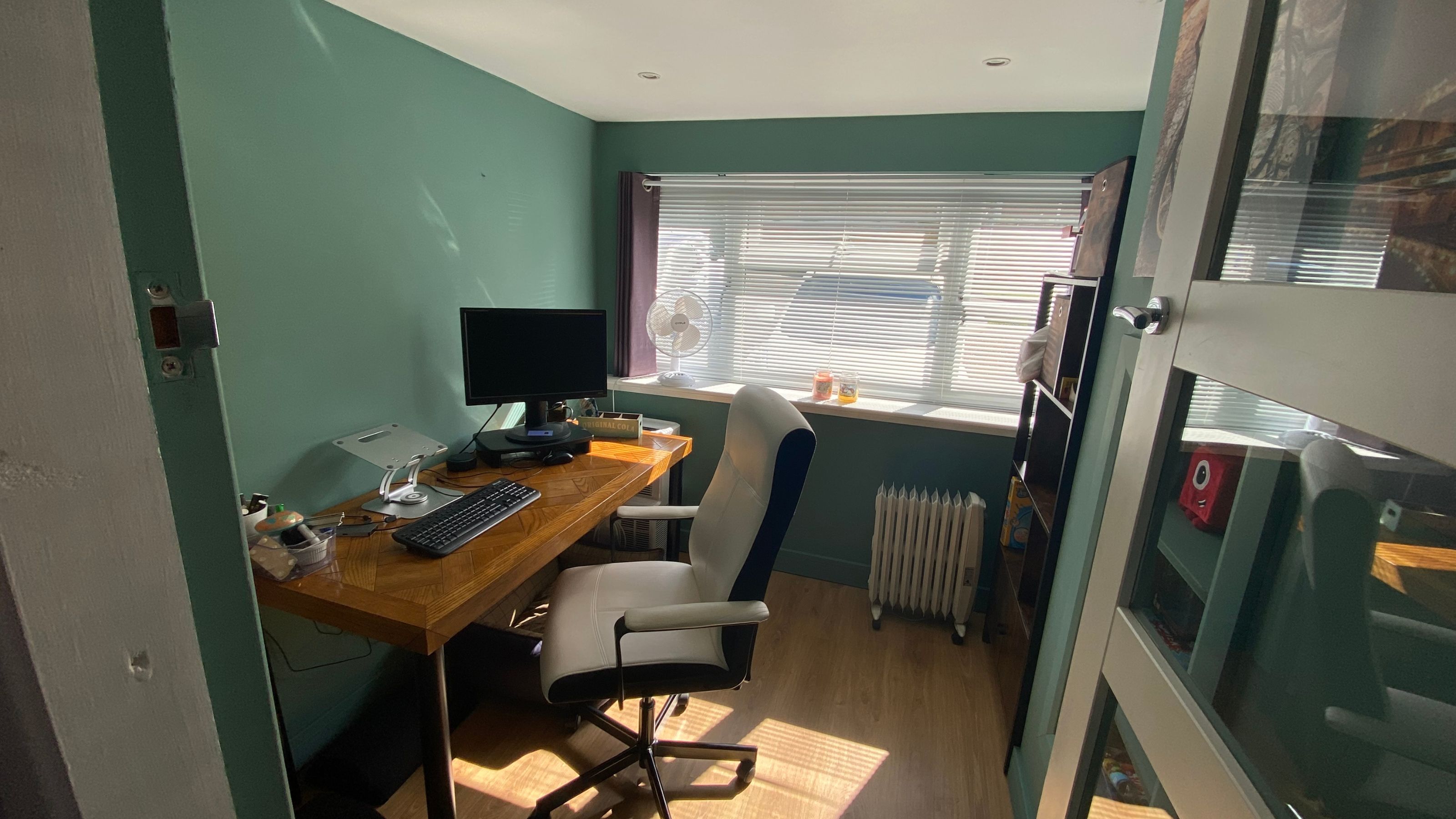 Home office in a converted garage with large window bringing in light