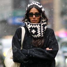 Woman walking through the snow, wearing black and white knit hood and sunglasses - kiehls ultra facial cream