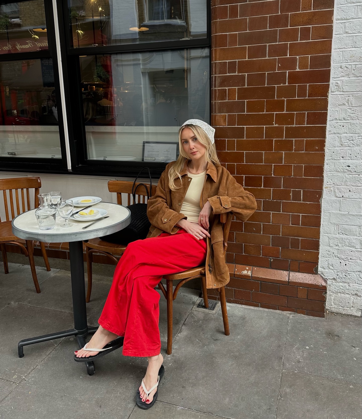 An image of @chloekathbutler wearing red jeans, one of the biggest summer jeans trends of 2026.