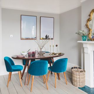 dining room with circular table and teal blue seats