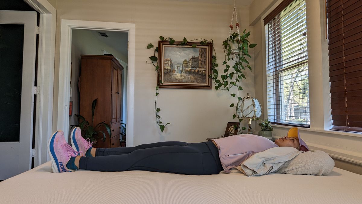 Our tester lying on the Essentia Stratami organic mattress to test its comfort and support